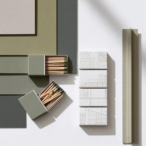 Cream rectangular drawer-style matchbox mockups arranged with coordinating neutral paper samples. The presentation shows sleeves, trays and the compact box proportions for bespoke event designs.