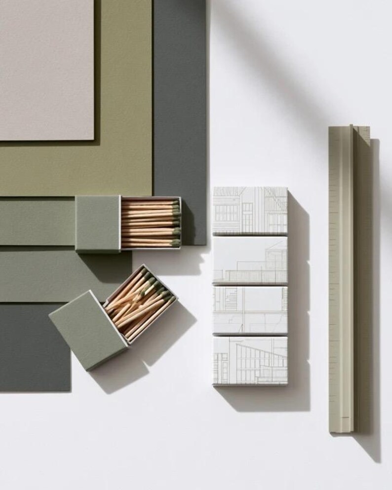 Cream rectangular drawer-style matchbox mockups arranged with coordinating neutral paper samples. The presentation shows sleeves, trays and the compact box proportions for bespoke event designs.