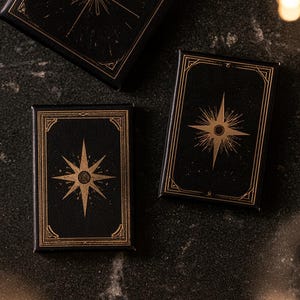 Dark matchbox mockups styled for an evening celebration, with plain and gold-toned decorative sleeve designs. The presentation shows compact rectangular boxes for personalised party favours.