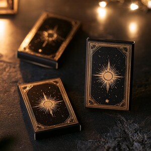 Dark matchbox mockups styled for an evening celebration, with plain and gold-toned decorative sleeve designs. The presentation shows compact rectangular boxes for personalised party favours.