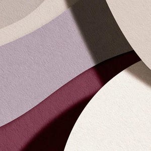 Layered unprinted menu-card mockups with curved paper edges in cream and muted burgundy tones. The arrangement shows contrasting paper shapes and soft shadows for a modern table-stationery design.