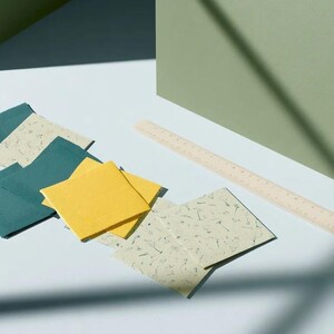 Square cocktail-napkin and paper-detail mockups with fine botanical line illustrations, styled with coordinating paper pieces. Digital presentation of a custom illustrated wedding and event design.