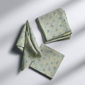 Square cocktail-napkin and paper-detail mockups with fine botanical line illustrations, styled with coordinating paper pieces. Digital presentation of a custom illustrated wedding and event design.