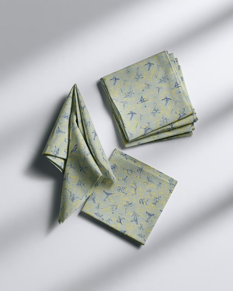 Square cocktail-napkin and paper-detail mockups with fine botanical line illustrations, styled with coordinating paper pieces. Digital presentation of a custom illustrated wedding and event design.