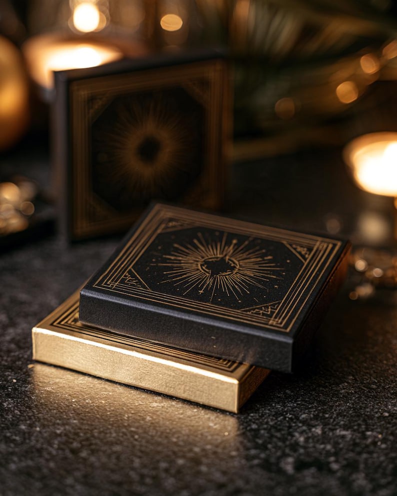 Black and gold New Year matchboxes with a starburst design