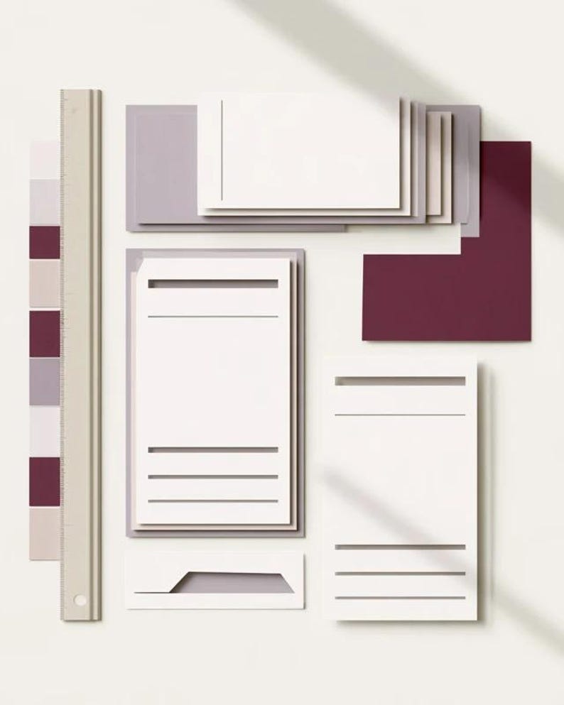 Layered unprinted menu-card mockups with curved paper edges in cream and muted burgundy tones. The arrangement shows contrasting paper shapes and soft shadows for a modern table-stationery design.