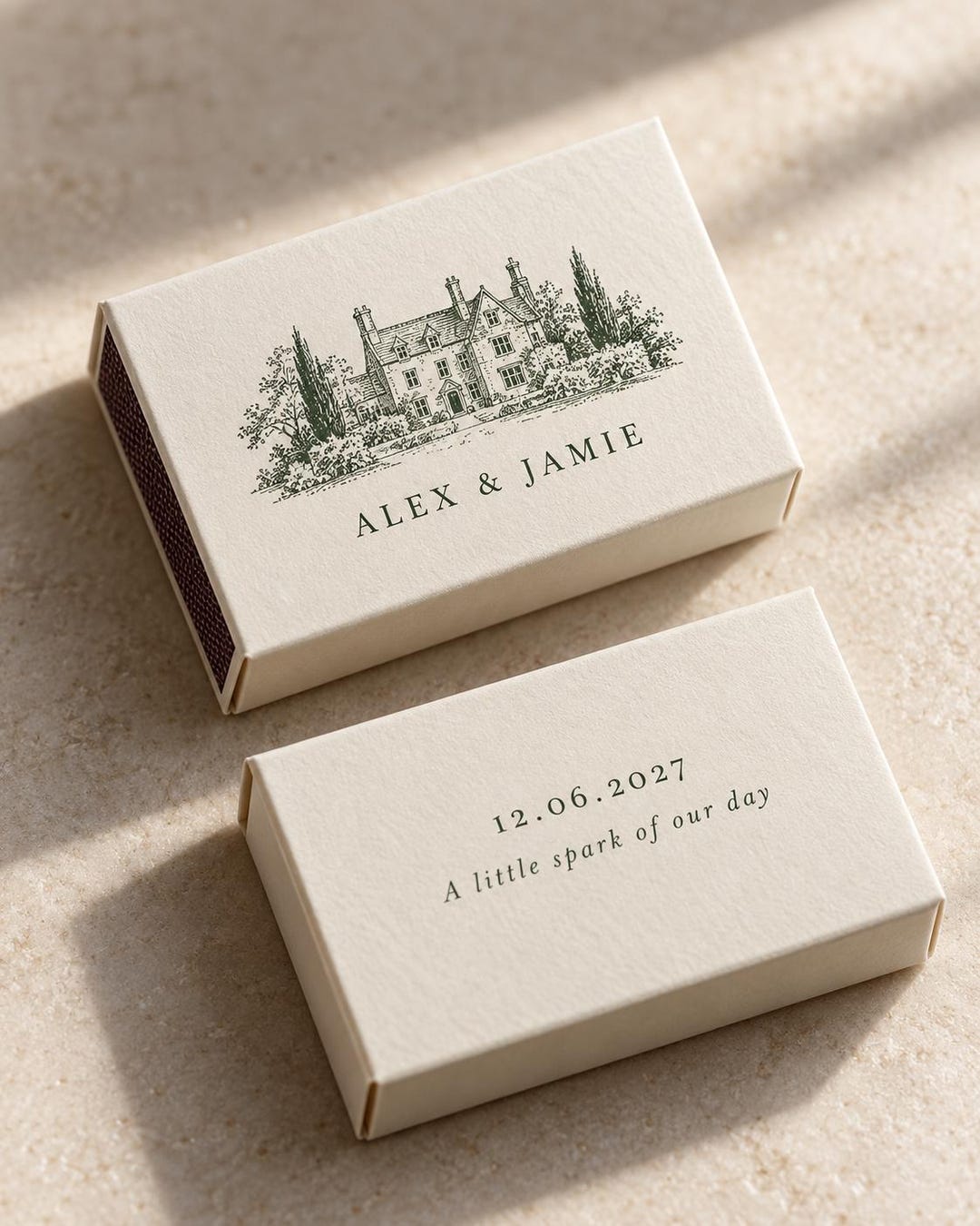Ivory matchboxes with a drawn country house and the names Alex and Jamie