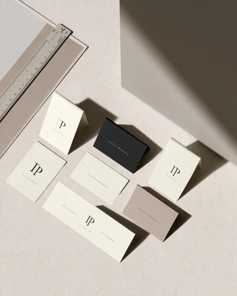 Folded place cards in cream, black and stone