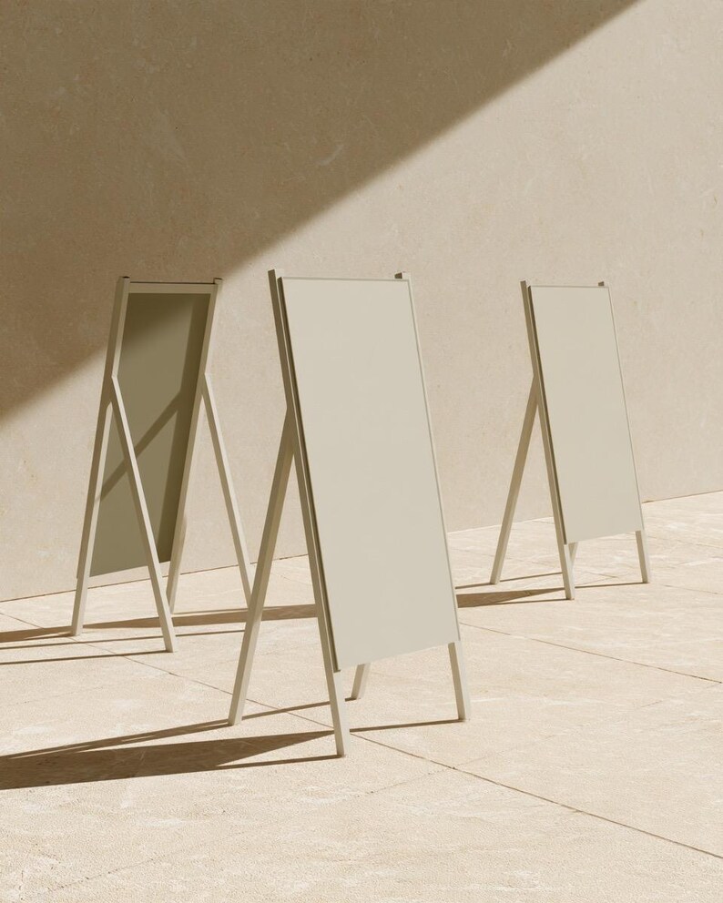 A tall cream wedding-sign mockup displayed upright with coordinated cream and olive paper stationery on a neutral surface. Soft daylight highlights the simple rectangular layout and paper textures.