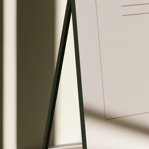 A tall cream wedding-sign mockup displayed upright with coordinated cream and olive paper stationery on a neutral surface. Soft daylight highlights the simple rectangular layout and paper textures.