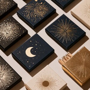 Dark matchbox mockups styled for an evening celebration, with plain and gold-toned decorative sleeve designs. The presentation shows compact rectangular boxes for personalised party favours.