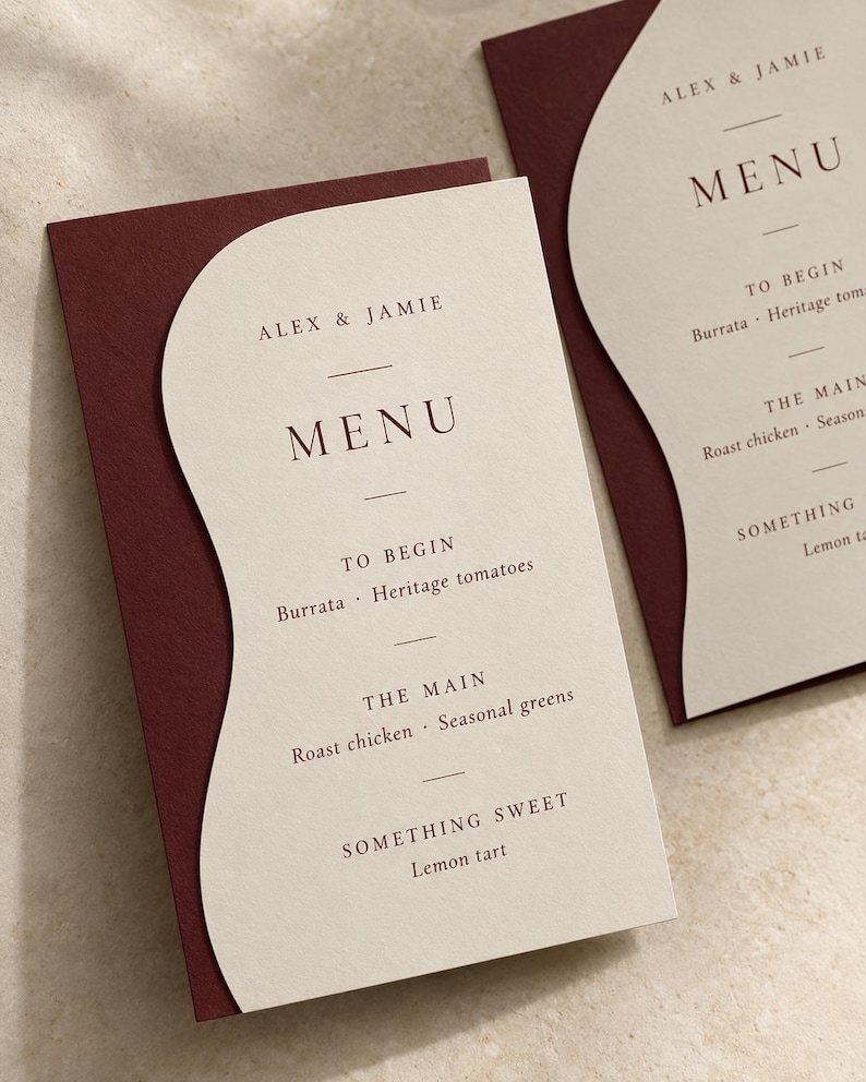 Layered menu card for Alex and Jamie on a burgundy backing
