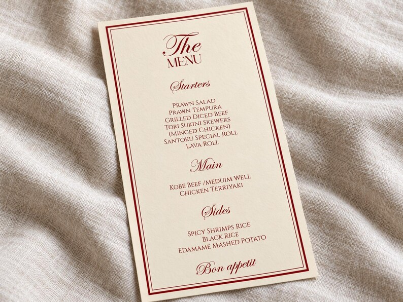 Może przedstawiać: Prostokątna karta menu w kolorze kremowym z ciemnoczerwoną obw&oacute;dką z podw&oacute;jnej linii. Tekst zawiera The Menu, Starters, Prawn Salad, Prawn Tempura, Grilled Diced Beef, Tori Sukini Skewers, Santoku Special Roll, Lava Roll, Main, Kobe Beef, Chicken Terriyaki, Sides, Spicy Shrimps Rice, Black Rice, Edamame Mashed Potato oraz Bon appetit.