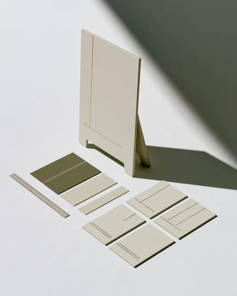 A tall cream wedding-sign mockup displayed upright with coordinated cream and olive paper stationery on a neutral surface. Soft daylight highlights the simple rectangular layout and paper textures.