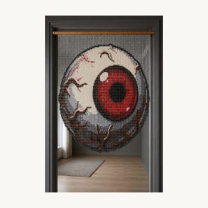 May include: A beaded doorway curtain featuring a large, circular graphic of a human eyeball. The iris is a deep red with a black pupil, while the sclera is white with grey shading and dark brown vein details, all suspended from a wooden rod.