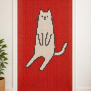 May include: A beaded door curtain featuring a red background with a white cat graphic outlined in black. The curtain is composed of numerous vertical strands of small, round beads suspended from a wooden rod, creating a pixelated cat image.
