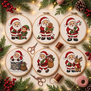 May include: Six circular wooden embroidery hoops featuring cross-stitch designs of Santa Claus with an elf, a gingerbread man, a candy cane, in a chimney, carrying a sack of gifts, and with a reindeer, accompanied by two pairs of scissors.