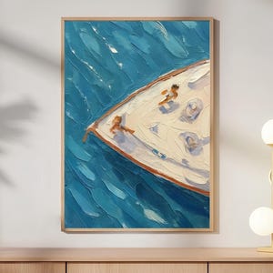 May include: An oil painting on canvas depicting an aerial view of a white boat bow cutting through deep blue, textured water. The artwork features thick, visible brushstrokes and two small figures on the deck, framed in a light wood frame.