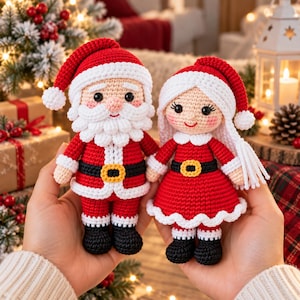 May include: Two handmade crochet dolls featuring Santa Claus and a companion, both wearing red and white outfits with black belts and gold buckles. Santa has a white beard and hat, while the companion has long white hair and a red hat.
