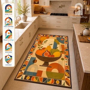 May include: A rectangular area rug featuring a central bowl of fruit including a pear, apple, orange, and fig. The design incorporates geometric shapes, lines, and a warm color palette of orange, yellow, green, and blue, with a dark border.