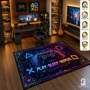 May include: A rectangular area rug featuring a black background with a vibrant neon-colored gaming controller graphic, geometric shapes, and the text PLAY SLEEP REPEAT in bold letters. The design includes blue, purple, and orange light accents.