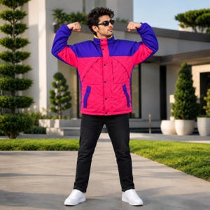 May include: A color-blocked jacket featuring a vibrant pink torso and sleeves with a deep purple upper chest and shoulder panel. The jacket has a high collar, a central button-down placket, and is paired with black trousers and white sneakers.