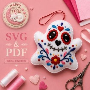 May include: A white felt ghost ornament featuring colorful embroidered floral patterns, red heart-shaped eye sockets, and a stitched mouth. The design includes a red hanging loop, accompanied by sewing supplies like thread spools and scissors.