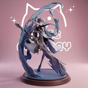 May include: A detailed anime-style figurine of a character with long light blue hair, wearing a white and blue outfit with flowing fabric elements. The character holds a staff and stands on a circular base, surrounded by swirling blue energy effects.