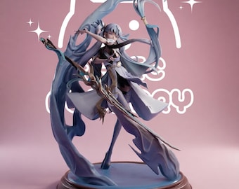 May include: A detailed anime-style figurine of a character with long light blue hair, wearing a white and blue outfit with flowing fabric elements. The character holds a staff and stands on a circular base, surrounded by swirling blue energy effects.