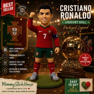 May include: A crochet doll of Cristiano Ronaldo wearing a red jersey with the number 7, green shorts, and grey shoes. The doll stands on a green circular base next to a gold soccer ball trophy on a wooden stand, with text including Best Seller.