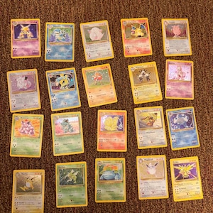 May include: A collection of seventeen vintage Pokémon trading cards arranged in a grid. The cards feature various characters including Alakazam, Blastoise, Chansey, Charizard, Clefable, Clefairy, Gyarados, Hitmonchan, Magneton, Mewtwo, Nidoking, Nidoqueen, Ninetales, Pidgeot, Poliwrath, Raichu, Scyther, Venusaur, Wigglytuff, and Zapdos, each with distinct artwork, text, and coloured borders.