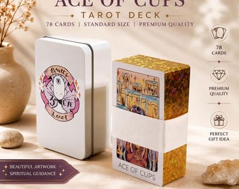 May include: A white rectangular metal tin featuring a circular logo with a third eye illustration and the text Britt's 3rd Eye Tarot, alongside a deck of 78 tarot cards with gold edges and a white paper band labeled Ace of Cups.