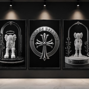 May include: A triptych of three framed wall art prints featuring a white cartoon figure with X-shaped eyes. The left and right panels show the figure under a metallic arch with roses. The center panel displays a large silver Chrome Hearts cross emblem.