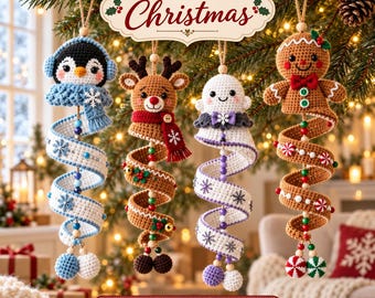 May include: Four crocheted Christmas ornaments featuring a penguin, a reindeer, a ghost, and a gingerbread person. Each figure has a long, spiraling tail decorated with beads and small motifs, hanging from a string against a festive tree background.