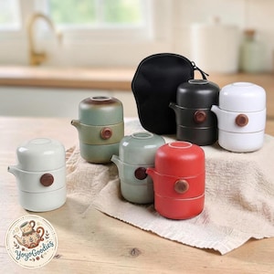 May include: A collection of portable tea sets in various colours including white, sage green, red, and black. Each set consists of a stacked teapot and cup with a small wooden knob on the side. A black zippered carrying case is included for storage.