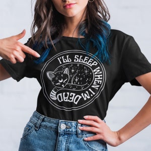 May include: Black t-shirt with a white graphic of a sleeping cat in a circle with the text "I'll sleep when I'm dead".