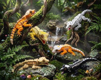 May include: Five articulated gecko figurines in various colors including orange, yellow, white with black spots, and black with white markings. The figures are positioned on mossy rocks and tree branches in a lush, green, forest-like environment.