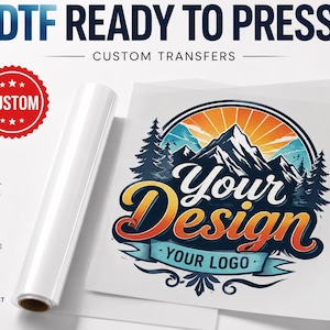 May include: A DTF ready to press custom transfer sheet featuring a mountain landscape graphic with the text Your Design and Your Logo. The design includes pine trees, a sunburst, and a banner. A red custom seal and icons for vibrant colors, soft and durable, and wash resistant are visible.