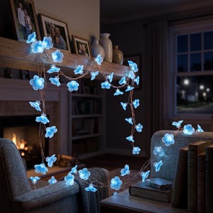 May include: A string of LED fairy lights featuring translucent, five-petaled blue flower covers. The lights are connected by a thin, flexible copper-colored wire, creating a glowing floral garland that illuminates with a cool blue light.