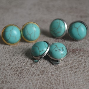 May include: A selection of turquoise stud earrings with gold or silver settings. The earrings feature a round, polished turquoise stone with brown veining. The image includes the text "ETSY ID: weddingpearl".