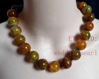May include: A necklace made of brown, green, and yellow agate beads. The beads are round and have a natural, polished finish. The necklace is approximately 18 inches long.