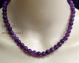 May include: A necklace composed of round, polished purple amethyst beads strung together in a single strand. The beads are uniform in size and colour, creating a continuous circular design. The text "ETSY ID: weddingpearl" is visible on the left.