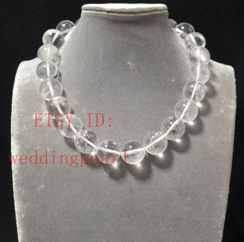 May include: A clear crystal bead necklace with a silver clasp. The necklace is on a white mannequin. The text "ETSY ID: weddingpearl" is visible in the image.