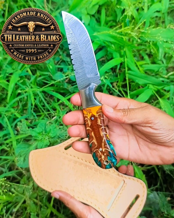 Hand-forged Damascus steel blade paired with turquoise-inlaid tooled leather sheath — a working knife that doubles as wearable Western art.