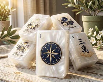 May include: A set of white pearlescent mahjong tiles featuring various illustrations including a compass, a crystal ball, an hourglass, and a hand, with text labels such as Flower, Joker, 1, and 3, and Chinese characters printed on the surface.