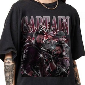 May include: A black short-sleeve t-shirt featuring a graphic print of Captain Price from Call of Duty. The design includes the text "CAPTAIN Price" in a bold font, layered over multiple depictions of the character with firearms and lightning.
