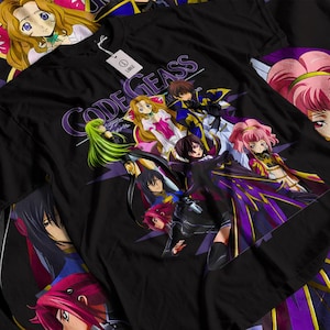May include: A black short-sleeve t-shirt featuring a large, colorful graphic print of multiple anime characters from Code Geass. The design includes the text Code Geass in a stylized purple font. A white size tag labeled L is attached to the collar.