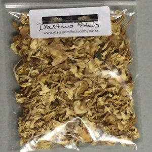 May include: A clear plastic bag filled with dried, light brown Dianthus petals. The bag has a white label with the text "Dianthus Petals" and the website address "www.etsy.com/shop/Madofthemors".