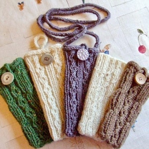 May include: Five knitted phone cases in different colors and patterns, each with a button closure. The cases are green, white, purple, white, and brown.