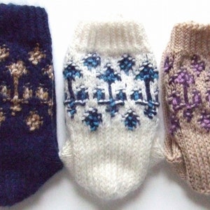 May include: Three pairs of knitted socks with different colored patterns. The first pair is navy blue with a tan and brown pattern. The second pair is white with a blue and white pattern. The third pair is tan with a purple and white pattern.
